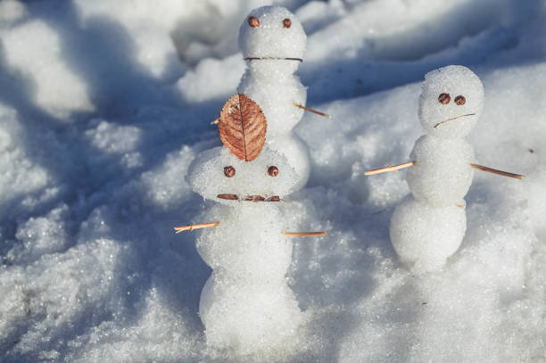 istock Sad snowmen. Spring came and the snow melts 953874462