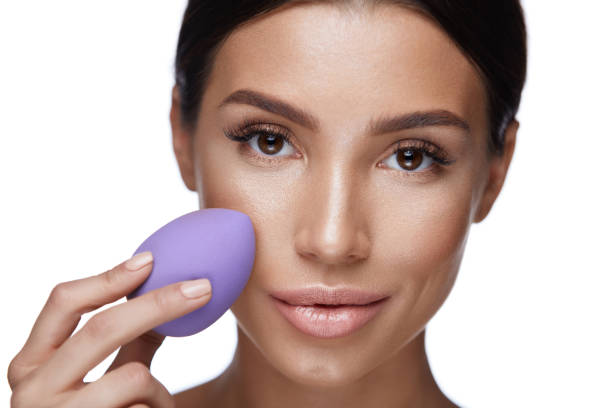 istock Beauty Makeup. Beautiful Woman Applying Foundation With Sponge 953879018