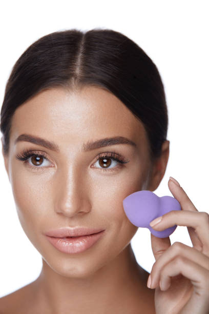istock Woman Applying Foundation. Beautiful Girl Applying Makeup 953880442