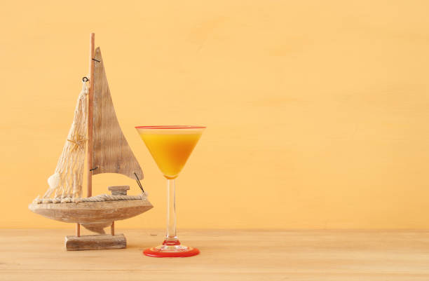 istock nautical concept with white decorative sail boat over wooden table. 953883446