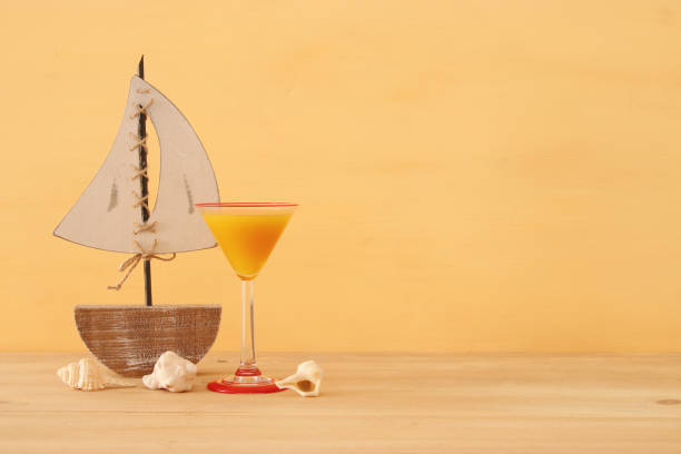 istock nautical concept with white decorative sail boat over wooden table. 953883466