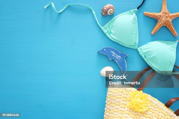 Vacation And Summer Image With Sea Life Style Objects And Mint Bikini Over Blue Wooden Background Stock Photo - Download Image Now