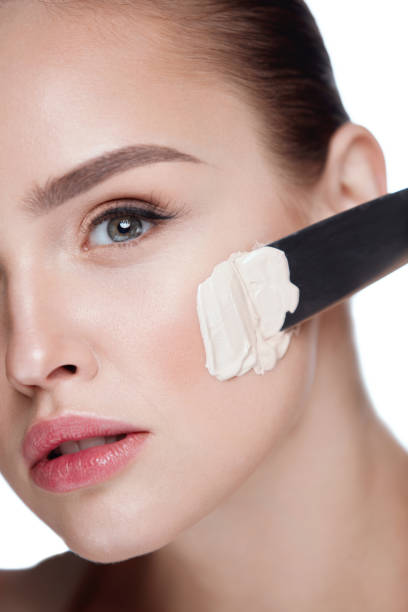 istock Beautiful Woman With Fresh Face Makeup Putting Foundation Cream 953887234