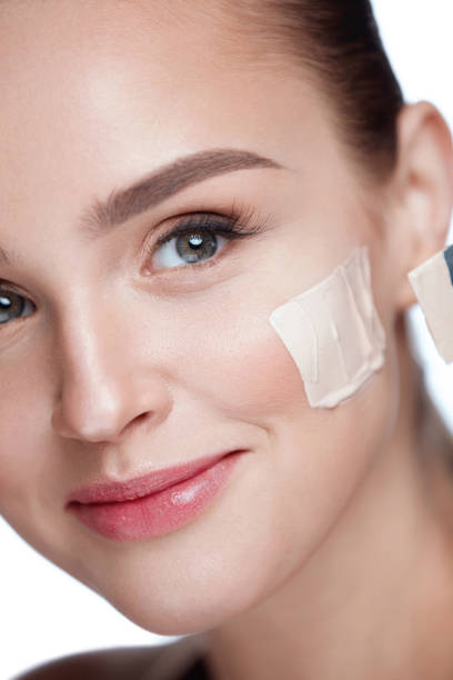 istock Sexy Female With Foundation Stripe On Cheek. Face Cosmetics 953887292