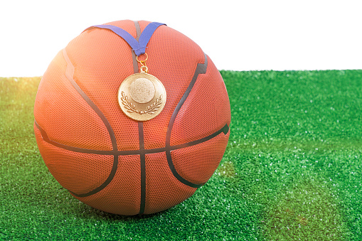 Basketball with medal on grass shot