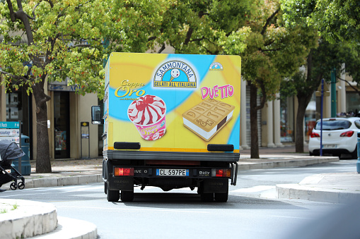 Menton: Italian Ice Cream Truck (Iveco Daily) Driving on The Road in The City Center Of Menton On The French Riviera