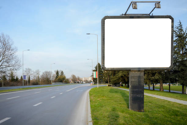 istock blank Billboard in the side of a road , fork or crossroad with blank billboard. 953896648