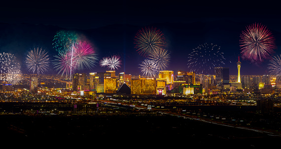 A panoramic stock photo of the Las Vegas city skyline with Fireworks exploding over the city.