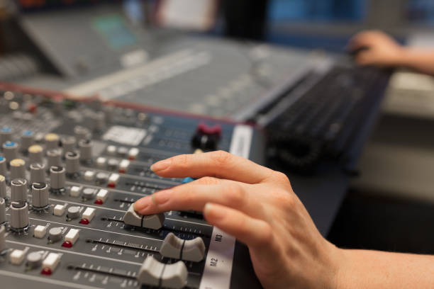 istock Female Radio Host Using Music Mixer In Studio 953897456