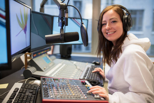 istock Confident Female Host Smiling In Radio Station 953897610