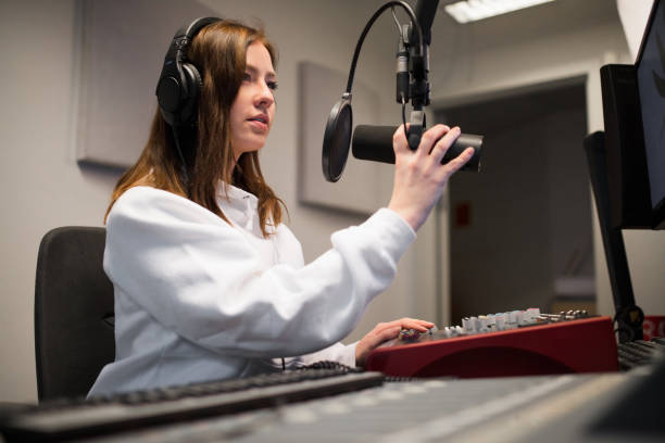 istock Radio Jockey Adjusting Microphone While Wearing Headphones In St 953897676