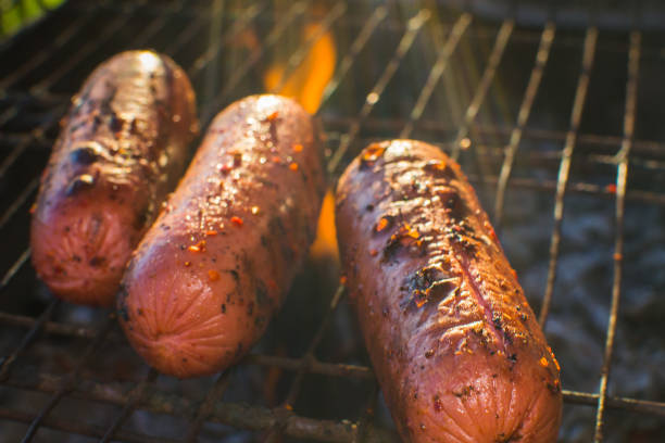 grilled sausages fried closeup grilled sausages fried closeup on fire picnic dangerous steak stock pictures, royalty-free photos & images