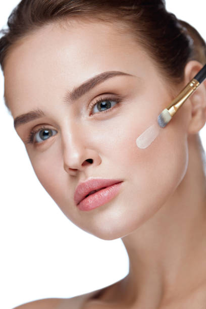 istock Woman Beauty Face Makeup. Female Applying Foundation 953898190