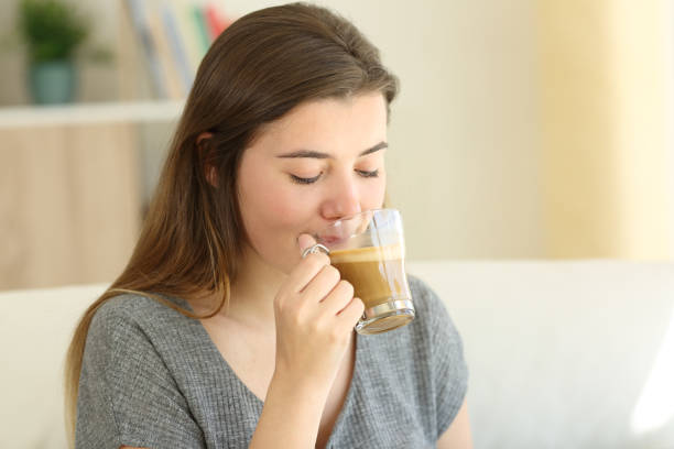 istock Teen drinking coffee with milk at home 953900446