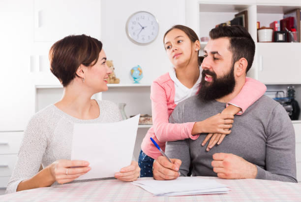istock Parents signing property papers 953902268