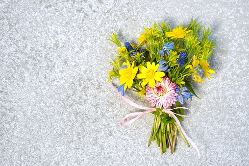 Beautiful bouquet of flowers against wooden background. Vintage styled.