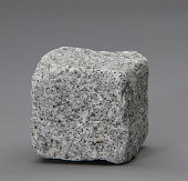 Granite cube on gray background