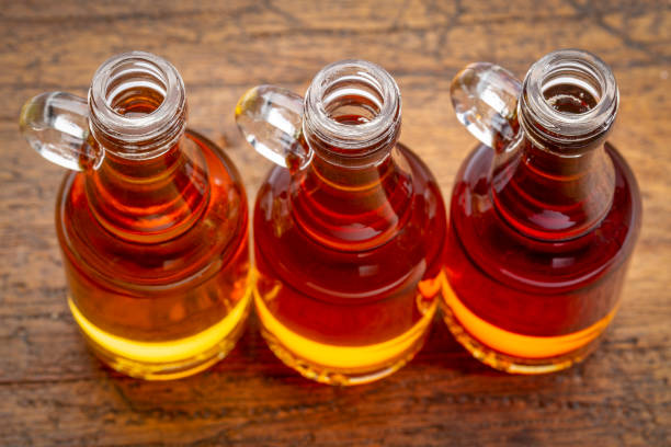 sampler of pure maple syrup sampler of pure maple syrup (golden, amber and gold) - small glass bottles against rustic wood maple syrup stock pictures, royalty-free photos & images