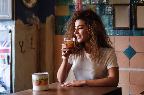 istock Arabic woman in a beautiful bar looking through the window 953918688