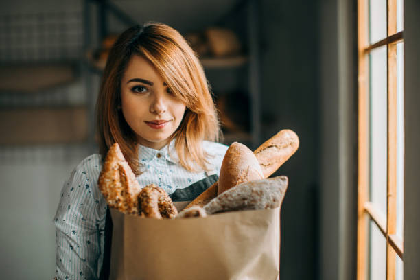istock Smiled woman holding bakery products 953919610