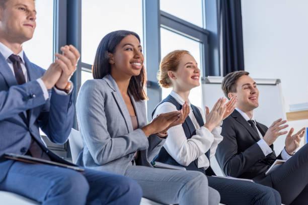 istock Young colleagues applauding to presentation in modern office 953921134