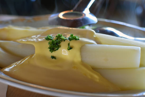 Fresh white asparagus from Beelitz (Germany), which is still steaming, on a plate with sauce hollandaise and asparagus tongs Fresh white asparagus from Beelitz (Germany), which is still steaming, on a plate with sauce hollandaise and asparagus tongs beelitz stock pictures, royalty-free photos & images
