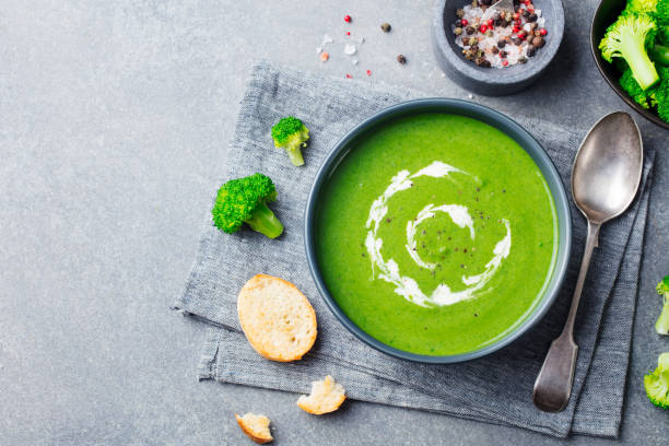Broccoli cream soup in a bowl with toasted bread. Top view. Copy space. Broccoli cream soup in a bowl with toasted bread. Top view. Copy space soup stock pictures, royalty-free photos & images