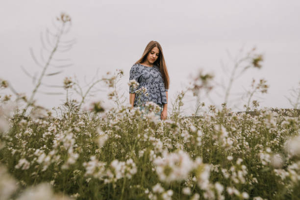 istock Young woman inside flower field 953929052
