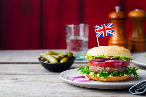 istock Burger with British flag on top. Wooden background. Copy space. 953932650