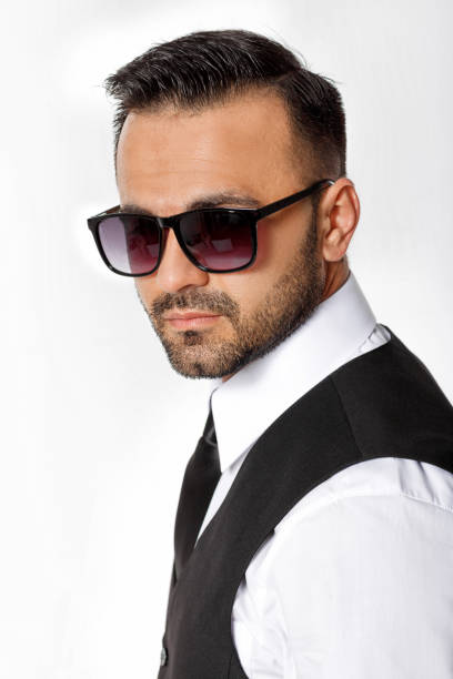 istock man in black suit on white background. 953933706