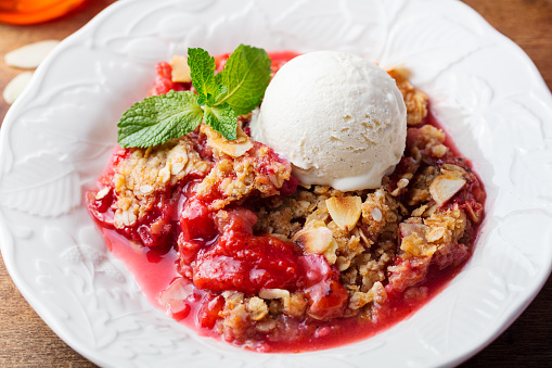 Crumble with berries and fruits with vanilla ice cream