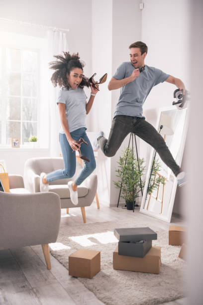 istock Happy delighted couple jumping 953933864
