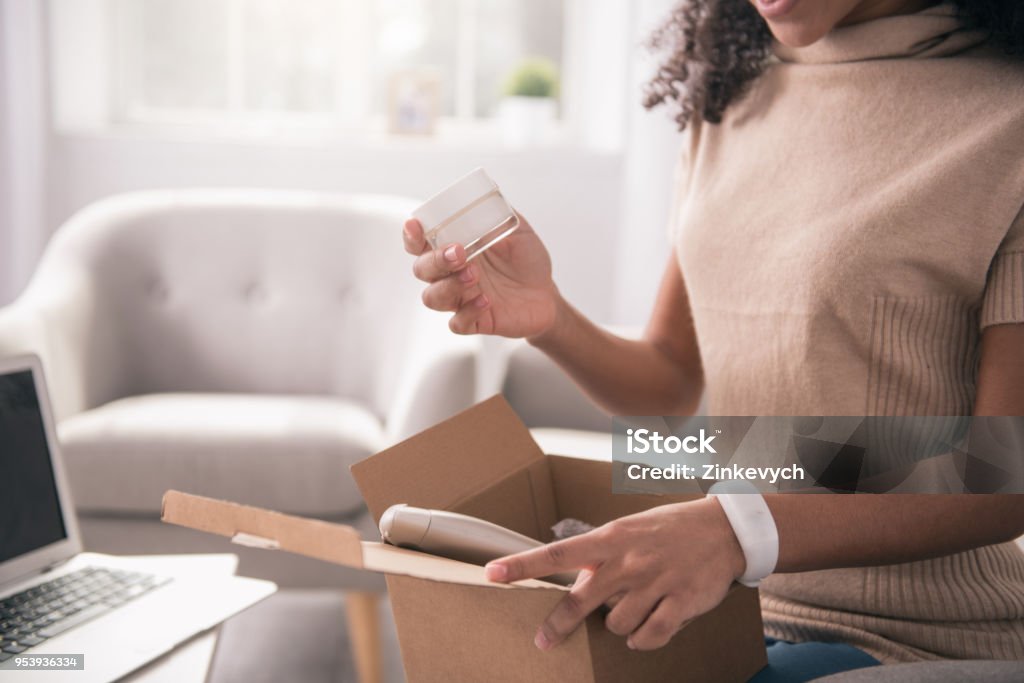 Close up of a package with cosmetics Internet order. Close up of an opened package with different cosmetics in it Online Shopping Stock Photo