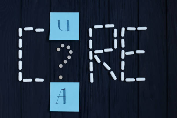 istock Table with tablets, pill capsules and color cards in shape of Ca 953936370