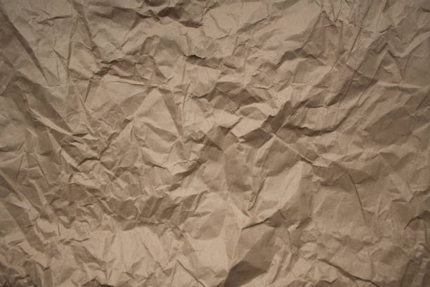 istock Brown rough crumpled recycled paper texture 953937050