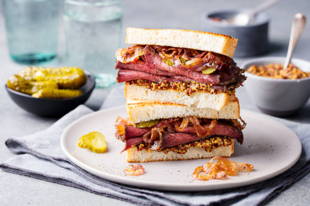 istock Roast beef sandwich on a plate with pickles. 953937560