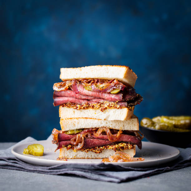 istock Roast beef sandwich on a plate with pickles. Copy space. 953937598