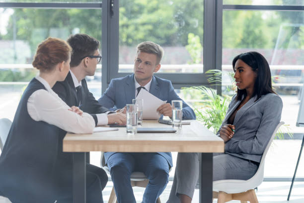 istock Behind the glass view of team discussing project in modern office 953937954