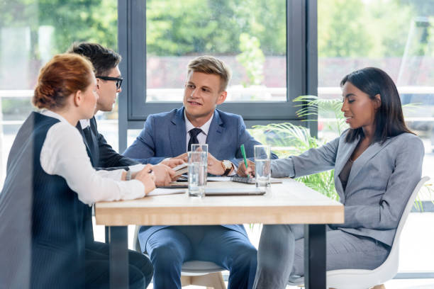 istock Behind the glass view of executives discussing project in modern office 953938166