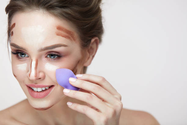 istock Face Makeup Beauty. Beautiful Female Applying Makeup With Sponge 953938466