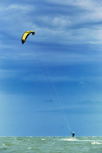 istock Man riding a kite surfing on the waves in the summer. 953938662