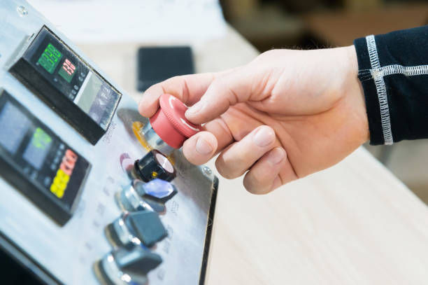 istock Close-up of a man's hand on a red button on the control panel. Emergency stop or start of equipment and production 953939214
