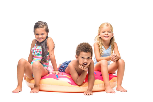 istock multiethnic kids on swim tube 953941450