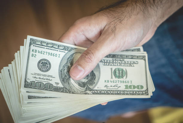 istock Hand holding Stack of Dollar Bank notes top view 953942962