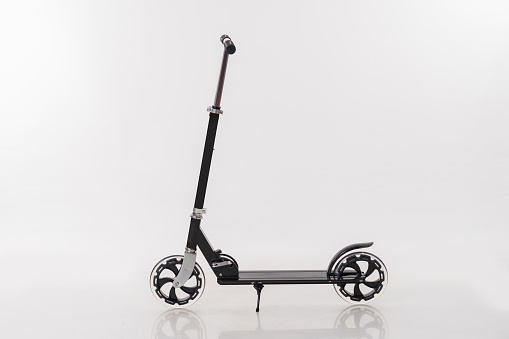 Black metal scooter over white background