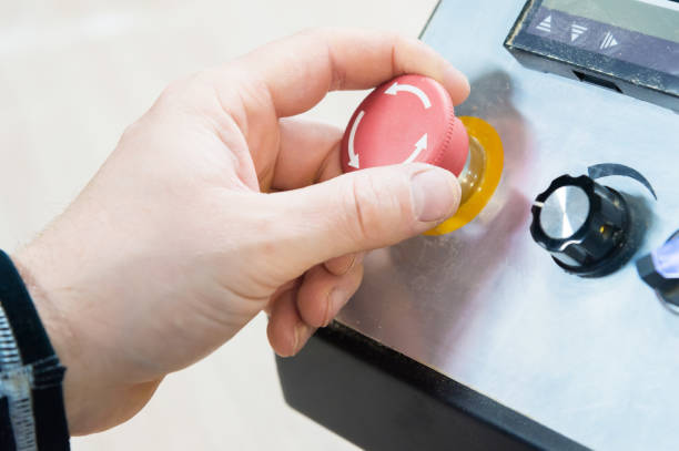 istock Close-up of a man's hand on a red button on the control panel. Emergency stop or start of equipment and production 953946730
