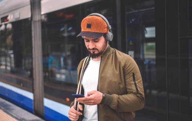 istock Portrait of handsome young man using a smart phone at train station 953948738