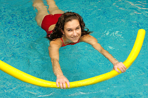 Water exercise. Girl learns to swimming stock photo