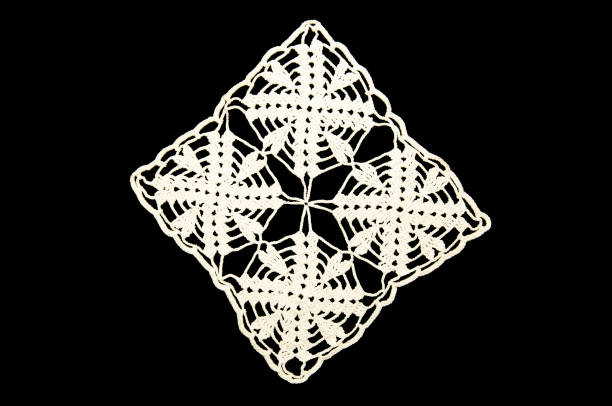 istock White hand made crocheted coaster lace doily on black background. 953951094