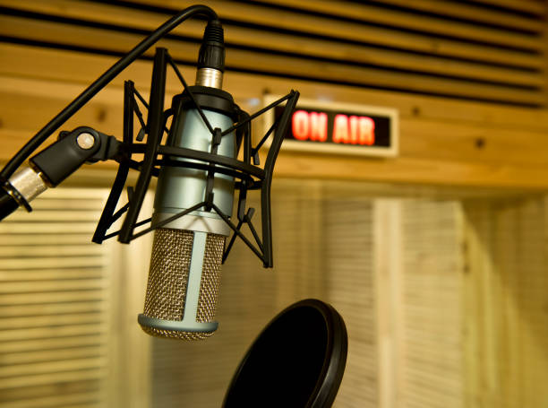 istock 'On air' sign turns on and a microphone in the studio 953951612